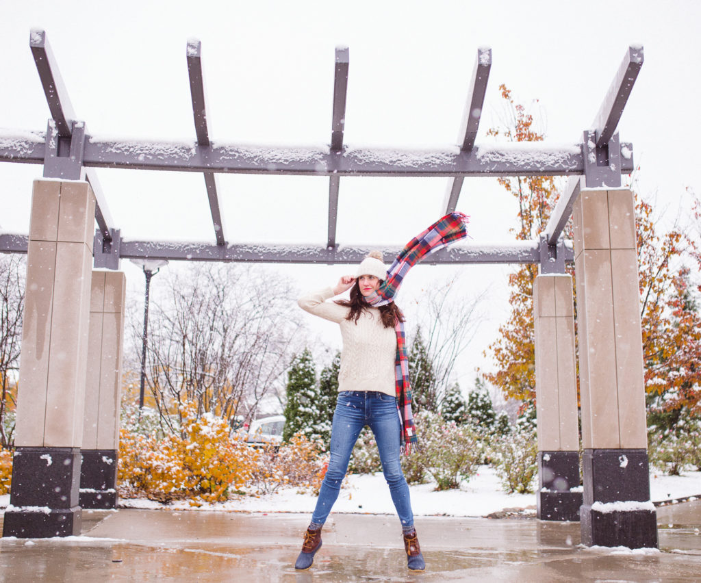 The lines above and to the side help to frame up the subject. Another line that was leveraged was the scarf -- by throwing it in the air, it created movement and interest, but it also helps to participate in the surrounding lines that are helping to draw the eye toward the subject.