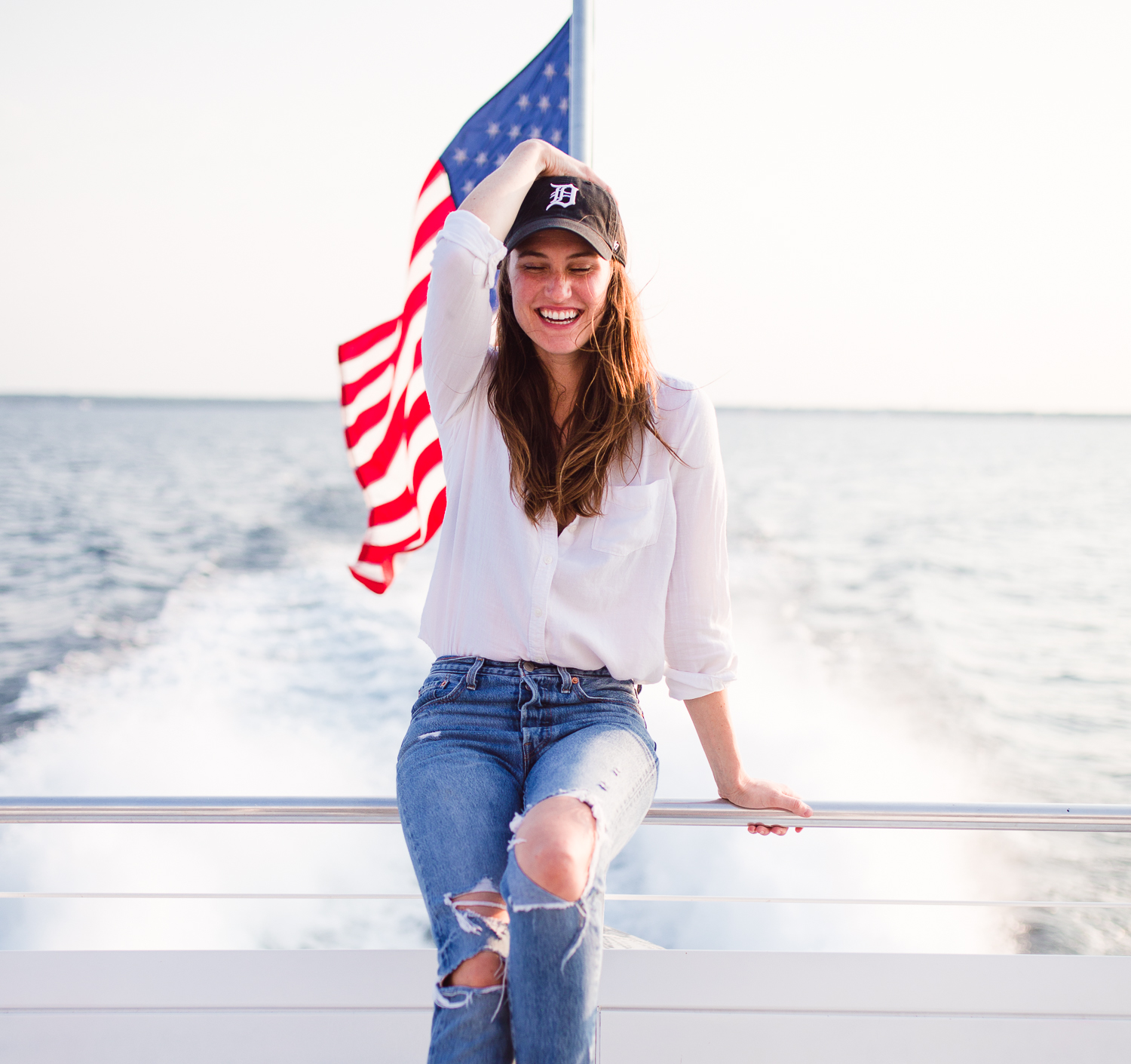 Jeans: Distressed Levi's Skinny Jeans. Levi's | Top: Cotton white button down | Bra: Free People Underwire Lace Bra | Hat: MLB Adjustable Detroit Tigers Hat | Necklace: Half moon crescent necklace.