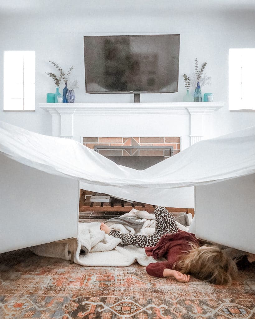 During a recent frigid cold snow day, Gracie and I turned off the TV and got creative by building a fort. Guess which option she preferred more? ;) // Chairs: Interior Define "Caitlin" by The Everygirl. Both in "Swan" structured cloth. | Rug: Loloi Loren Terracotta and Sky Rug | Ottoman: Caden Leather Square Ottoman