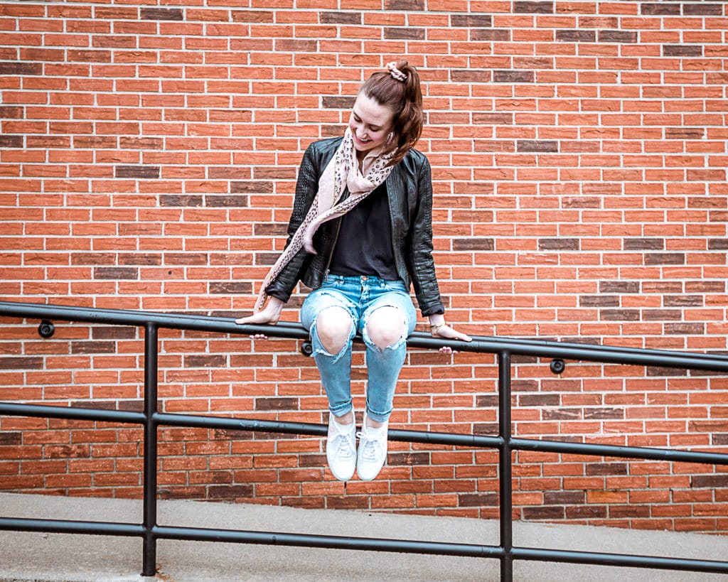 Emily Charron is wearing the best distressed denim jeans and VEJA sneakers.