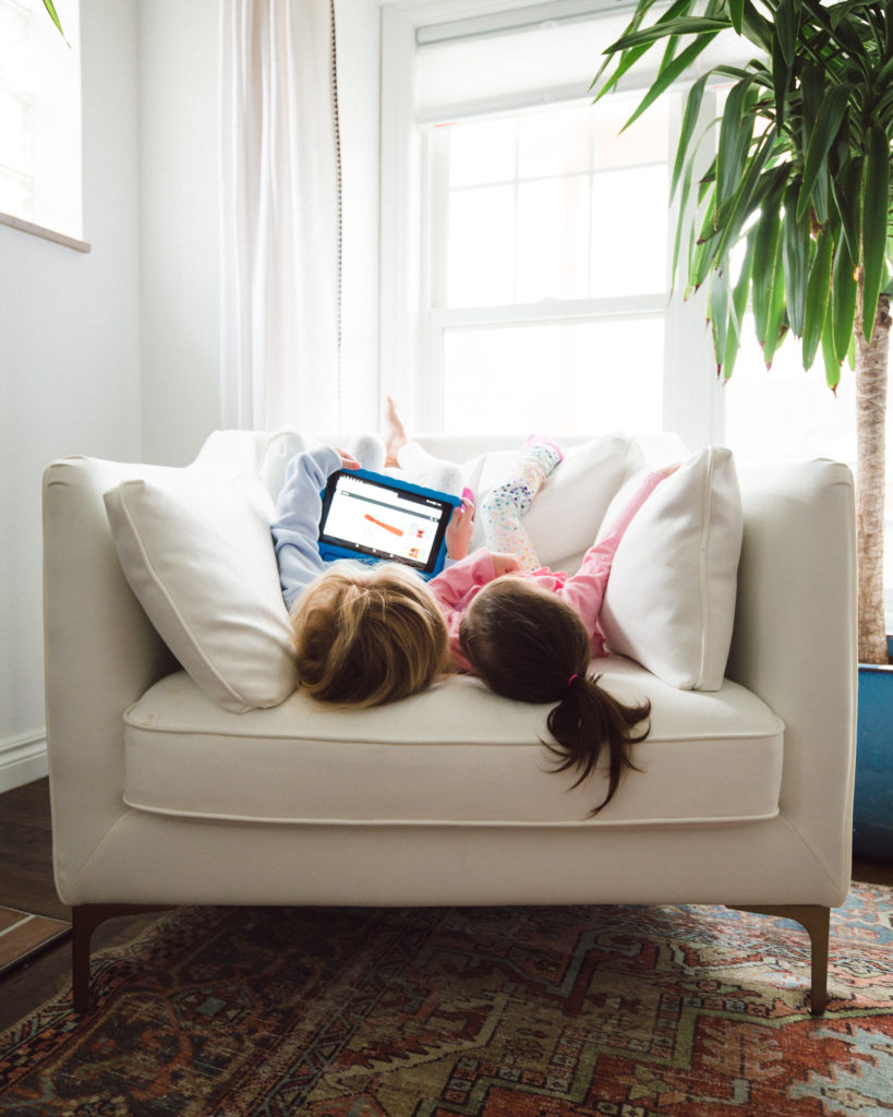 YouTube channels for young kids, watching tablet on chair