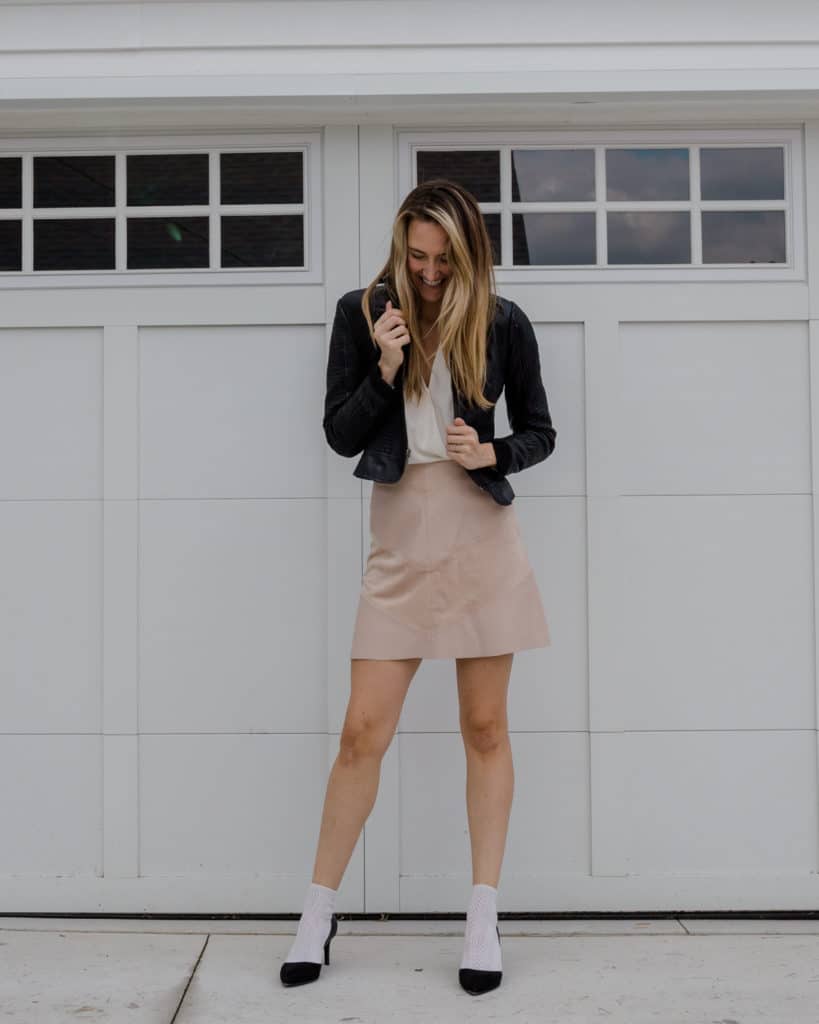 Leather jacket, wearing socks and heels, blush skirt